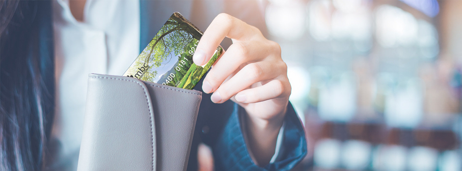 customer pulling Pinnacle Horizon Bank Debit Card from their wallet